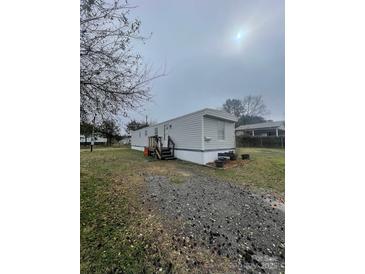 Charming single-story home features a gravel driveway and well-maintained lawn at 412 Sumter St # A, Clover, SC 29710