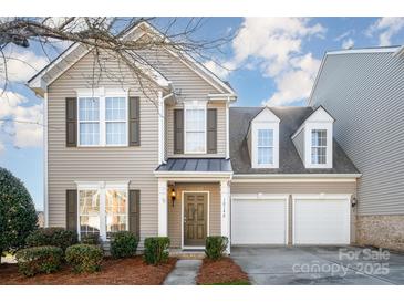 Charming two-story home featuring a welcoming front porch and a well-maintained lawn with mature landscaping at 10142 Linksland Dr, Huntersville, NC 28078