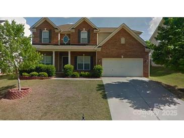 Charming two-story brick home with a well-maintained lawn and inviting curb appeal at 10546 Tintinhull Dr, Indian Land, SC 29707