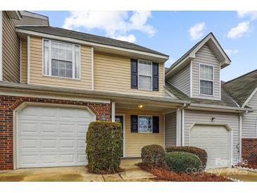 Charming townhome features neutral siding, a brick accent, and an attached one-car garage at 1386 Walnut Hill Dr, Rock Hill, SC 29732