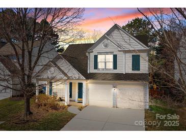 Charming two-story home with a two-car garage and beautiful sunset sky at 18016 Bluff Inlet Rd, Cornelius, NC 28031