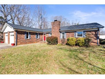 Charming single story brick home featuring blue shutters, a red front door, and mature landscaping at 2659 Surrey Dr, Lincolnton, NC 28092