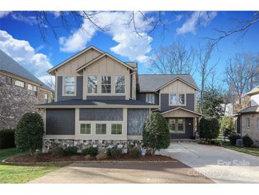 Beautiful two-story home with stone accents, a well-manicured lawn, and neutral-colored siding at 4124 Sherbrooke Dr, Charlotte, NC 28210