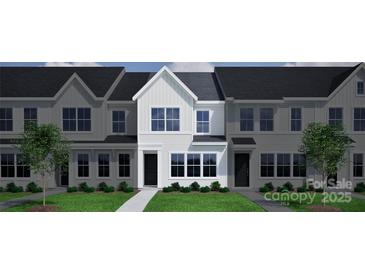 Modern townhome featuring a clean white facade, dark roof, and well-manicured front lawn at 4714 Lakeview Rd, Charlotte, NC 28216