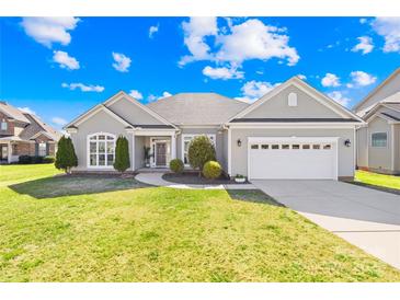 Charming one-story home featuring manicured lawn, landscaped entryway and a two car garage at 7362 Vanguard Ct, Stanley, NC 28164