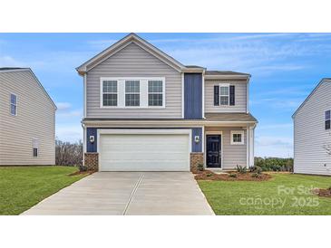 Charming two-story home featuring gray siding, a two-car garage, and a welcoming front entrance at 115 Dorian Pl, Troutman, NC 28166