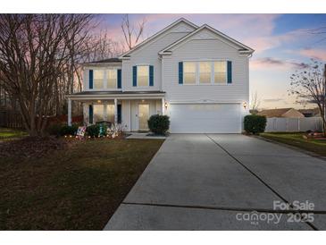 Charming two-story home with blue shutters, attached two-car garage, and well-manicured front lawn at 3247 Bamburgh Ct, Charlotte, NC 28216