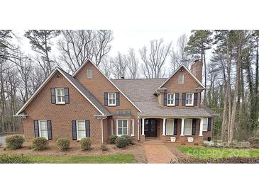 Charming brick home with dark shutters and a welcoming front porch at 720 9Th Nw Ave, Hickory, NC 28601