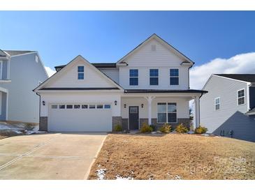Charming two-story home with white siding, a well-manicured lawn, and an attached two-car garage at 107 Megby Trl, Statesville, NC 28677