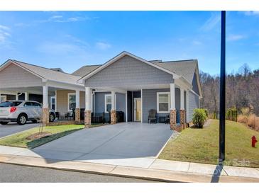 Charming gray home with a covered driveway and cozy front porch seating area at 2802 15Th Avenue Se Pl, Hickory, NC 28602