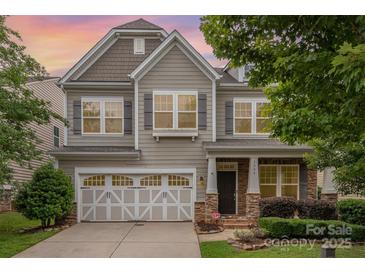 Charming two-story home featuring a two-car garage, stone accents, and manicured landscaping at 3004 Fallondale Rd, Waxhaw, NC 28173