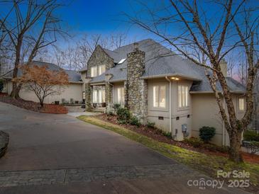Stately home featuring a stone chimney and accents, complimented by a circular driveway and mature trees at 503 Stuart Rdg, Cramerton, NC 28032