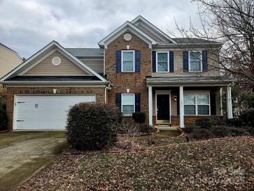Charming two-story home with a two car garage, brick and vinyl siding and blue shutters at 6237 Shelley Ave, Charlotte, NC 28269