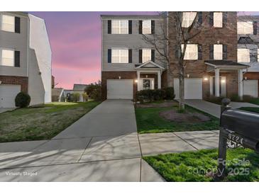 Charming townhome with attached garage, landscaped yard, and inviting entrance at 9724 Walkers Glen Nw Dr, Concord, NC 28027