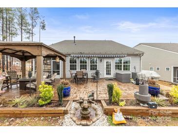 Serene backyard featuring a patio area, gazebo, and garden beds at 1029 Dali Blvd, Mount Holly, NC 28120