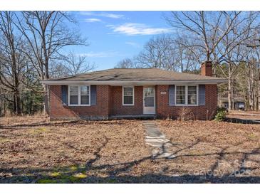 Charming brick home featuring symmetrical window placement and a well-maintained front yard at 1874 Mcilwain Rd, Lancaster, SC 29720