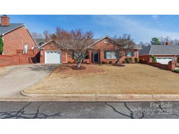 Charming single-story brick home features a well-manicured front yard and attached garage at 1910 Connemara Ct, Gastonia, NC 28054