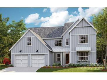 Charming two-story home with a two-car garage, gray siding, and a beautifully landscaped front yard at 2000 Stratford Ave, Charlotte, NC 28205