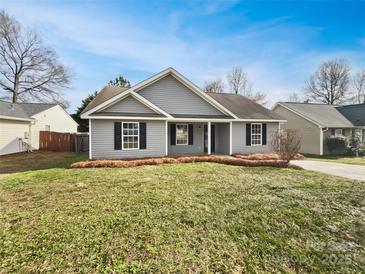 Charming single-story home featuring gray siding, black shutters, and a well-manicured lawn at 313 Pelling Dr, York, SC 29745