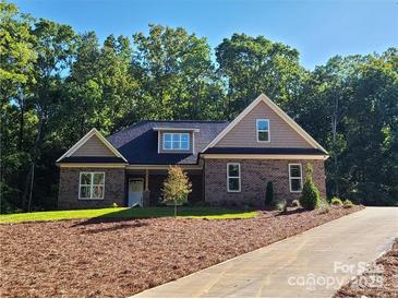 Charming brick home featuring manicured landscaping and a classic architectural design at 404 Imperial Way, Albemarle, NC 28001