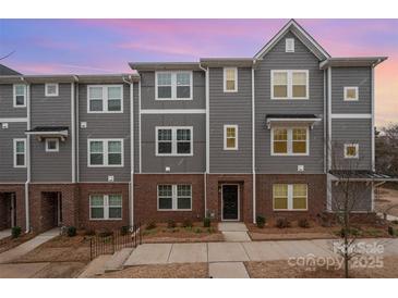 Charming townhome exterior featuring neutral siding, brick accents, and well-maintained landscaping at 4548 Millennium Ave, Charlotte, NC 28217