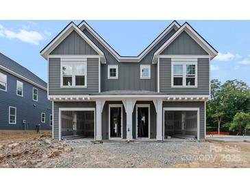 New construction two-story home with gray siding, white trim, covered porch, and garage at 507 Bowman Rd, Charlotte, NC 28217