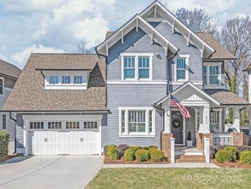 Charming two-story home featuring a two-car garage, manicured lawn, and inviting front porch at 5717 Closeburn Rd, Charlotte, NC 28210