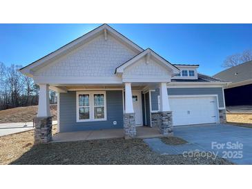 Charming new construction home featuring a welcoming front porch and attached two car garage at 602 Banter Ln # 28, Cramerton, NC 28032