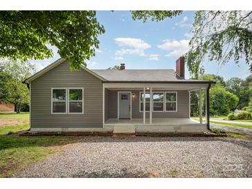 Charming home featuring neutral siding, chimney and a cozy front porch at 621 Bristol Dr, Statesville, NC 28677