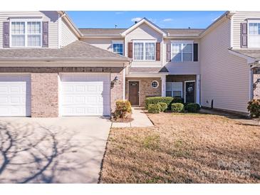 Charming two-story townhouse featuring an attached garage and well-maintained landscaping at 10316 Stineway Ct, Pineville, NC 28134