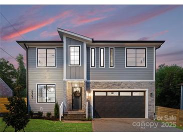 Beautiful two-story home with a gray exterior, stone accents, and an attached two-car garage at 2965 Beech Nut Rd, Charlotte, NC 28208
