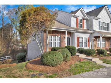 Charming townhome showcasing a well-manicured lawn and a mix of brick and siding details at 3099 Windsor Trace Dr, Fort Mill, SC 29707