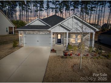 Charming single-Gathering home featuring stone accents, a two-car garage, and a welcoming front porch at 4321 Duplin Dr, Charlotte, NC 28214