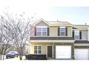Charming two-story townhome features a one car garage, stone accents, and tasteful curb appeal at 11029 Ardglass Ct, Charlotte, NC 28213