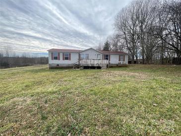 Exterior shot of a single-story home with a red roof and front porch at 134 Garett Ln, Harmony, NC 28634