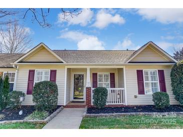 Charming single-story home featuring manicured landscaping and a welcoming front porch at 1362 Copper Creek Ln, Fort Mill, SC 29715