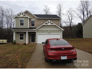 Charming two-story home features a red car parked on the driveway at 232 Sugar Hill Rd, Troutman, NC 28166
