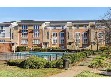 Beautiful condo building with brick and siding and a community pool at 3949 Picasso Ct, Charlotte, NC 28205