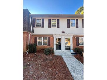 Traditional two-story townhome with red brick and symmetrical facade at 5810 Hunting Ridge Ln # C, Charlotte, NC 28212