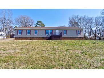 Charming single-story home with neutral siding, red shutters, and a welcoming front porch at 828 Carver St, Shelby, NC 28152
