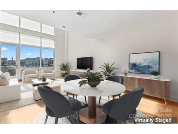 Bright open-concept living area with floor to ceiling windows and modern decor at 1133 Metropolitan Ave # 310, Charlotte, NC 28204