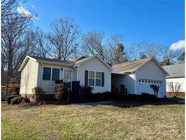 Charming single-story home featuring neutral siding, attached garage, and front yard with mature trees at 1420 28Th Sw St, Hickory, NC 28602