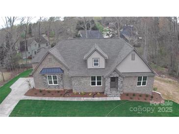Charming brick home featuring a manicured lawn, stylish dormer, and inviting entryway at 2069 Landry Ln # 233, Rock Hill, SC 29732