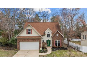 Charming two-story home with a well-manicured lawn and brick accents creating curb appeal at 207 Pebble Creek Xing, Fort Mill, SC 29715