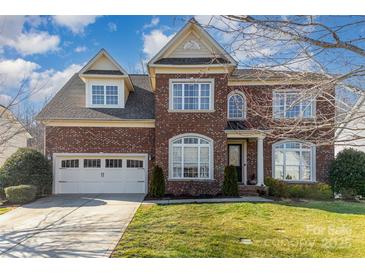 Charming brick two-story home featuring a well-manicured lawn and an attached two-car garage at 3046 Denali Way, Rock Hill, SC 29732