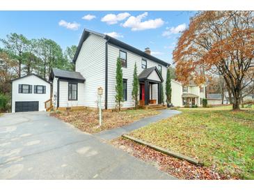 Charming two-story home with classic black and white trim and a detached garage at 8730 Rittenhouse Cir, Charlotte, NC 28270