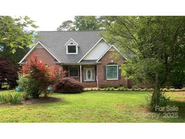 Charming brick home with a well-manicured lawn and lush landscaping, offering great curb appeal at 912 Silver Charm Ln, York, SC 29745
