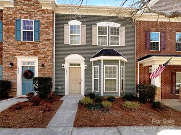 Charming townhome with a landscaped front yard and a mix of brick and siding facade at 13811 Waverton Ln, Huntersville, NC 28078