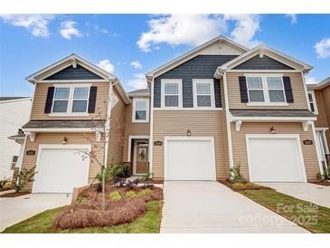Charming townhome featuring a well-maintained lawn, attached garages, and classic design at 2320 Hedgecliff Rd # 158, Kannapolis, NC 28025