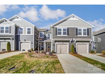 Charming townhome featuring a one-car garage, beautiful landscaping, and a well-maintained lawn at 2330 Hedgecliff Rd # 157, Kannapolis, NC 28025